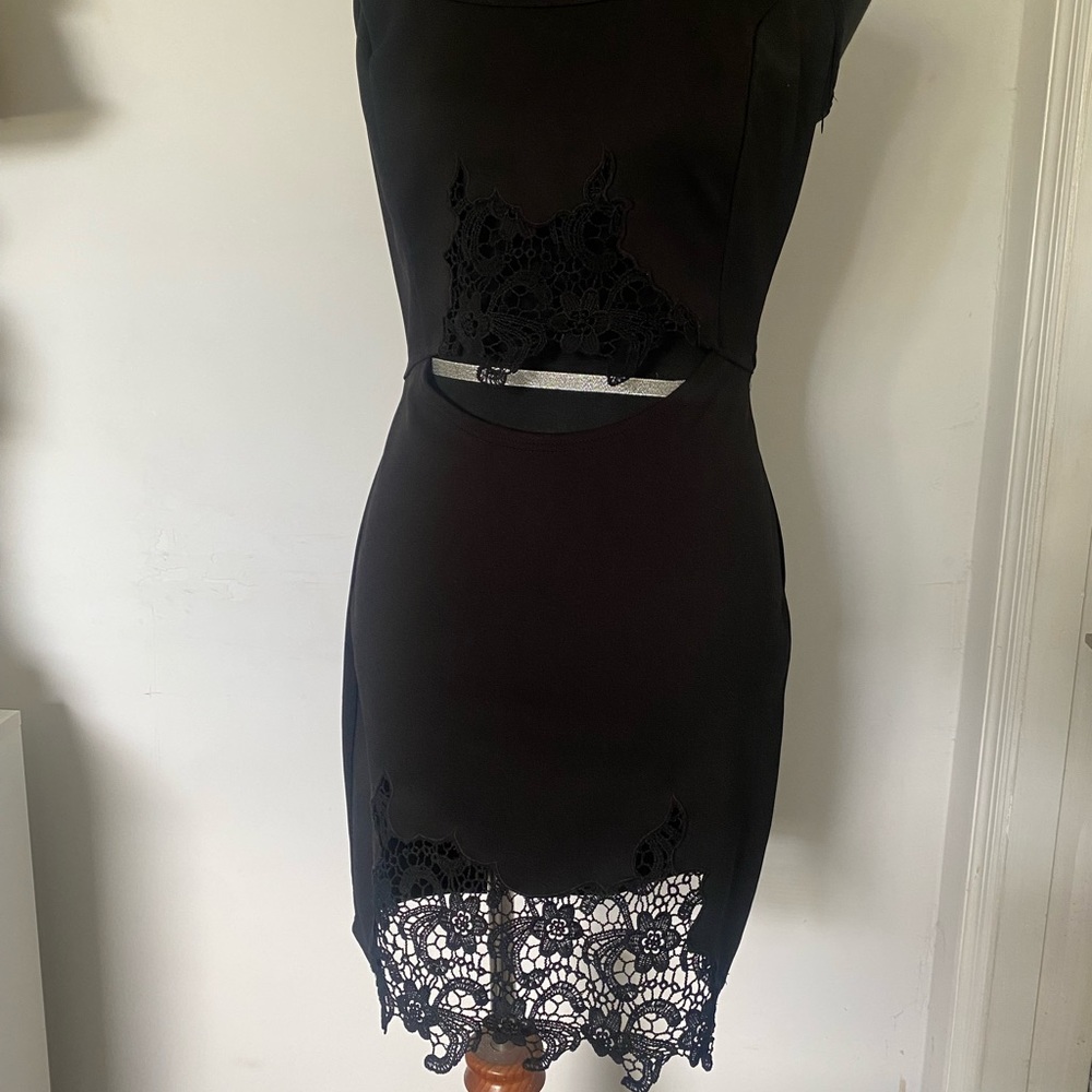 Black little dress with embroidery detailing on hem and waist.